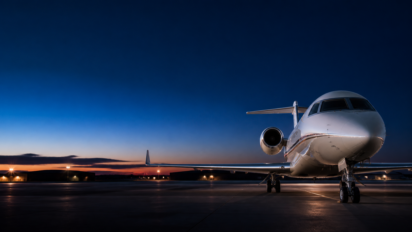 Business aircraft on an airport ramp at dawn